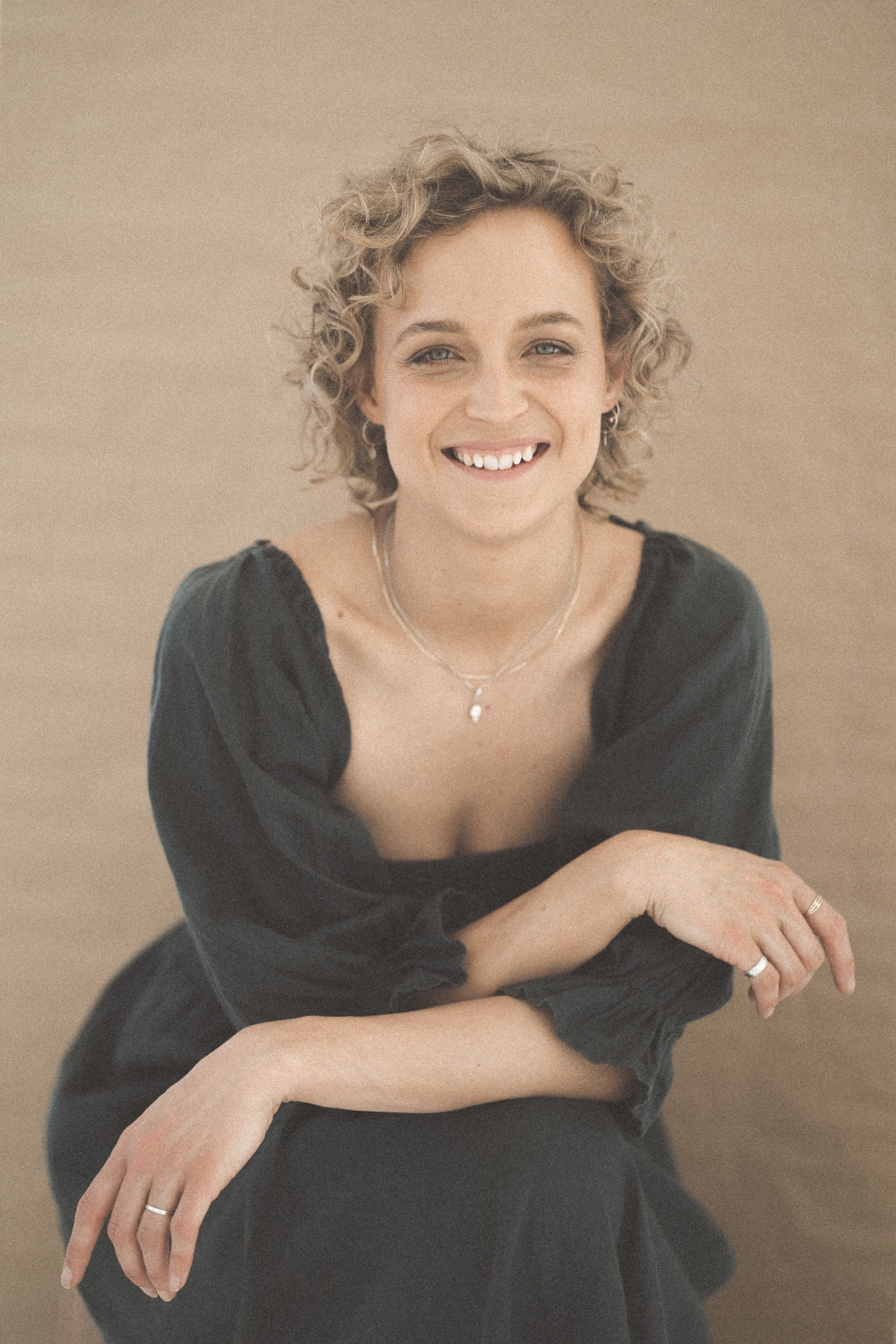 Emma, holistic facialist and founder of Slow Skin Co, smiling and posing