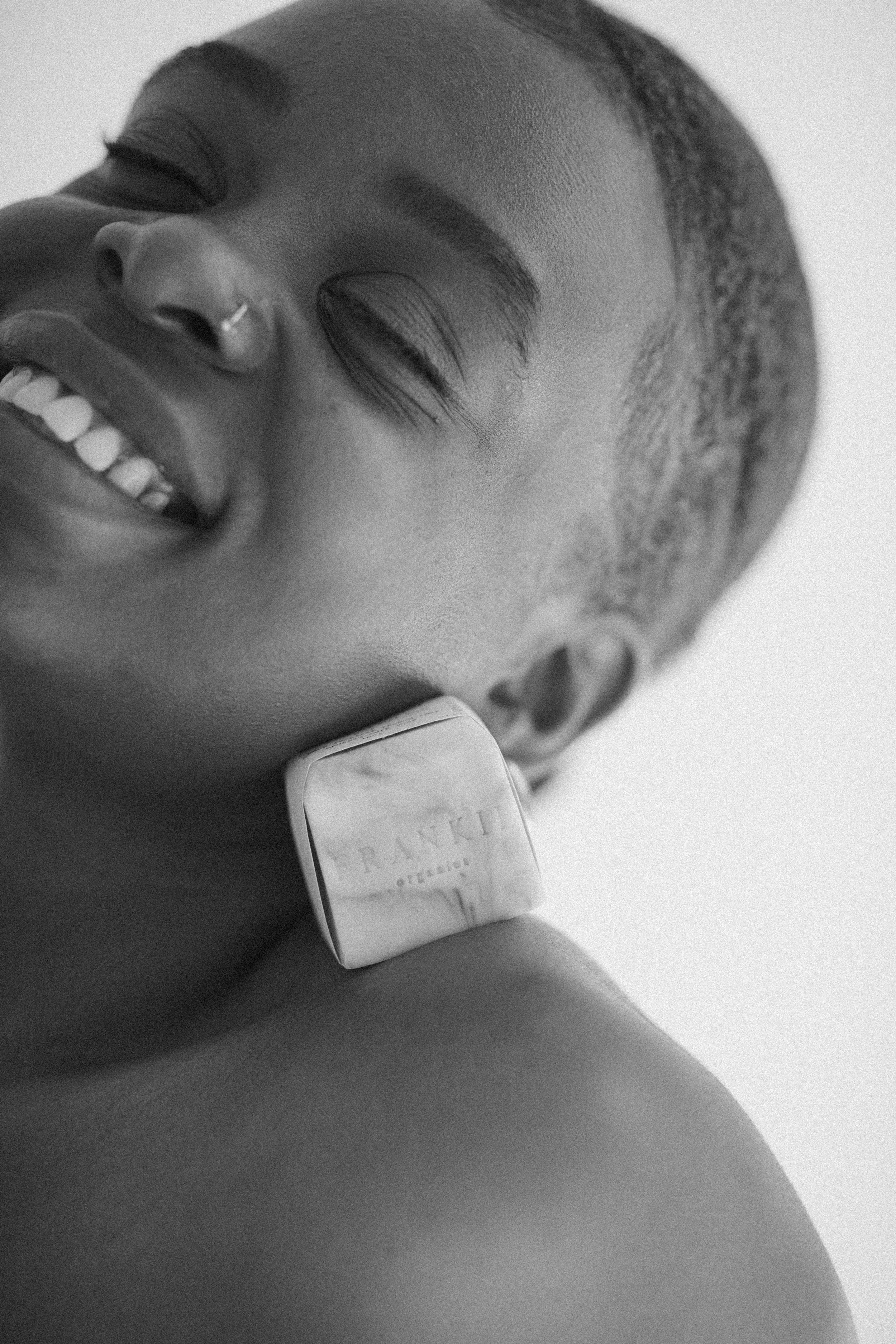 Woman smiling and holding a bar of organic soap