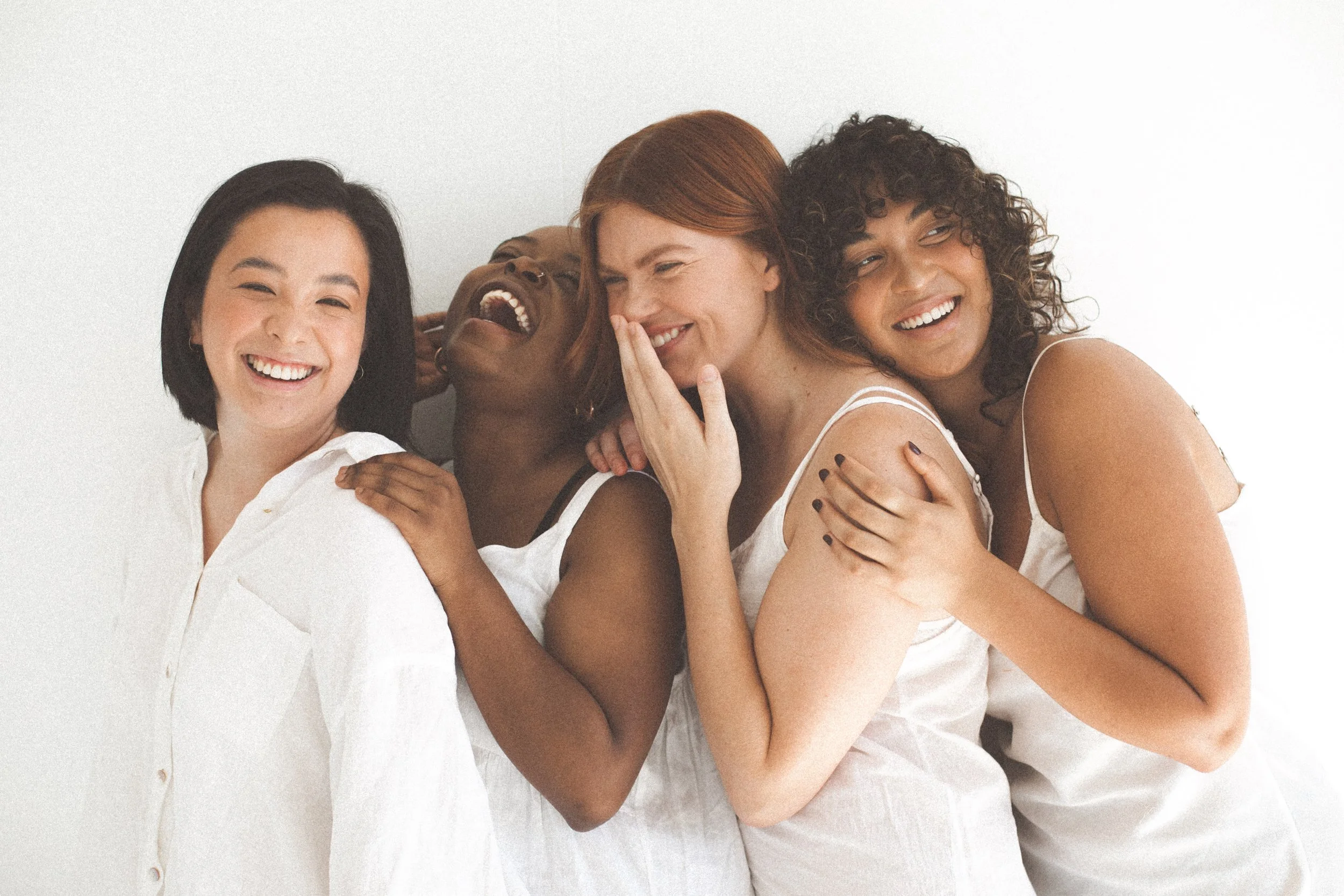 Group of women posing and smiling together