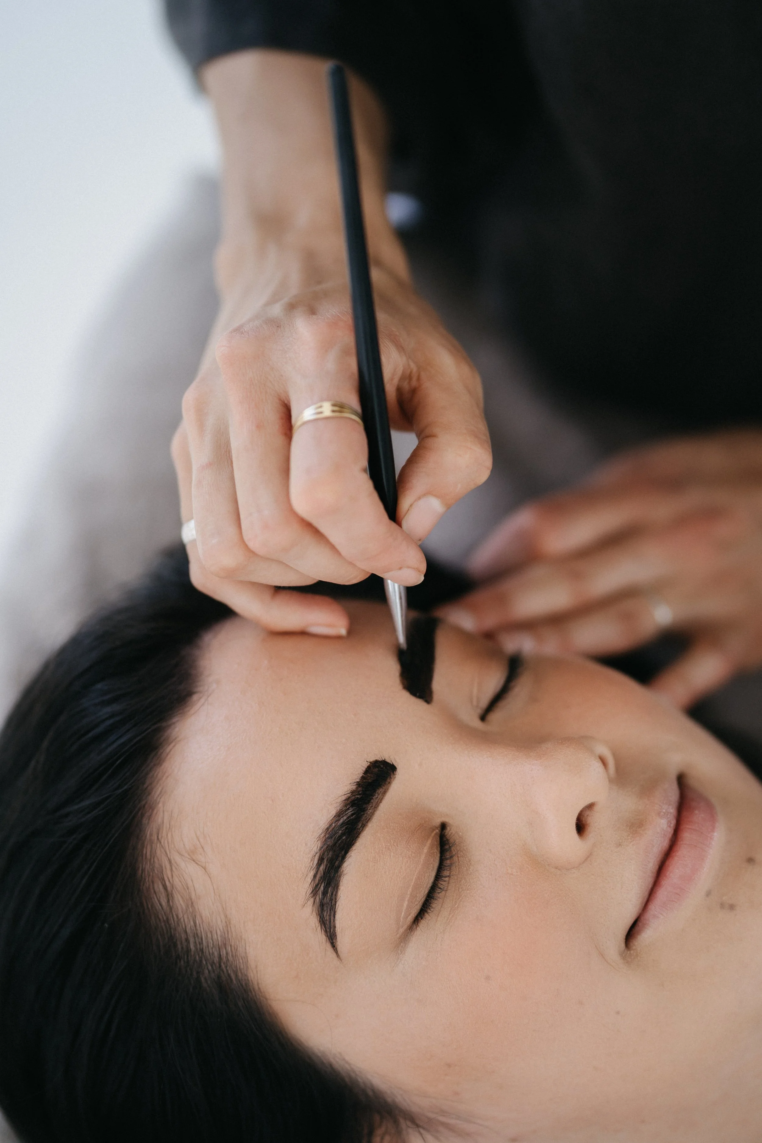 Woman getting brow hair tinted professionally