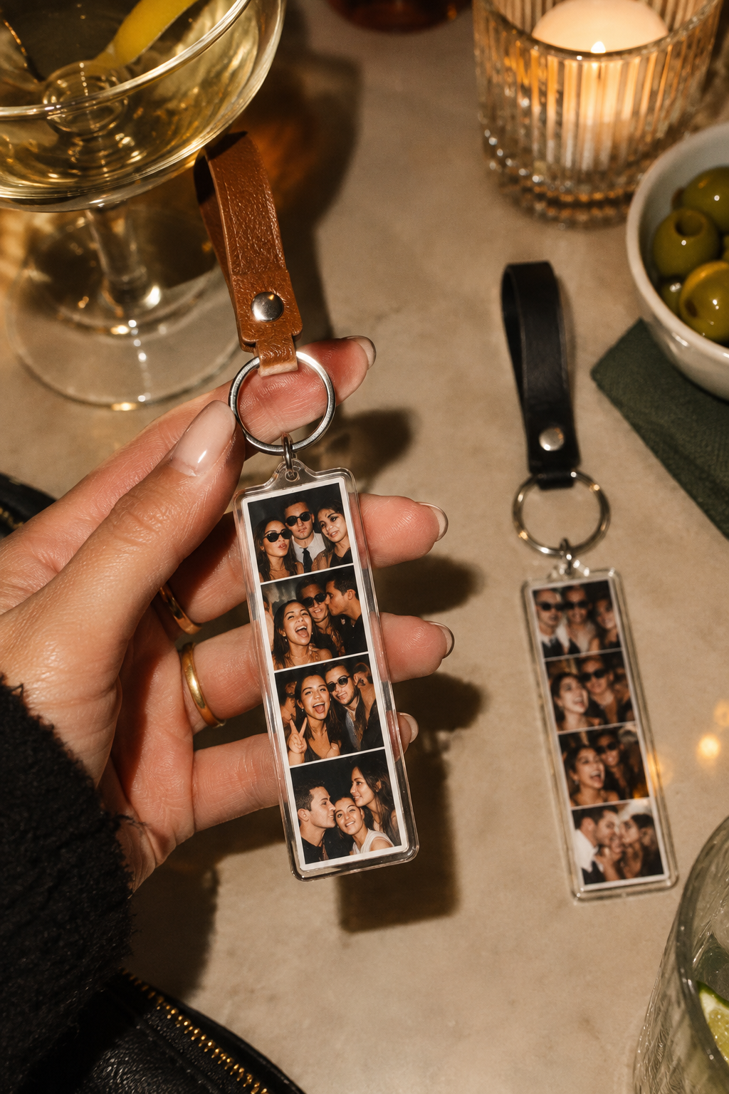shows a lady holding a photobooth key chain from a photobooth event