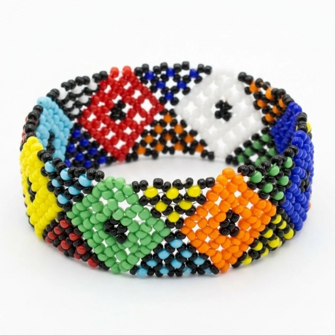 Beaded bracelet featuring colorful geometric patterns, including diamonds, triangles, and squares, in red, blue, green, yellow, orange, black, and white beads.