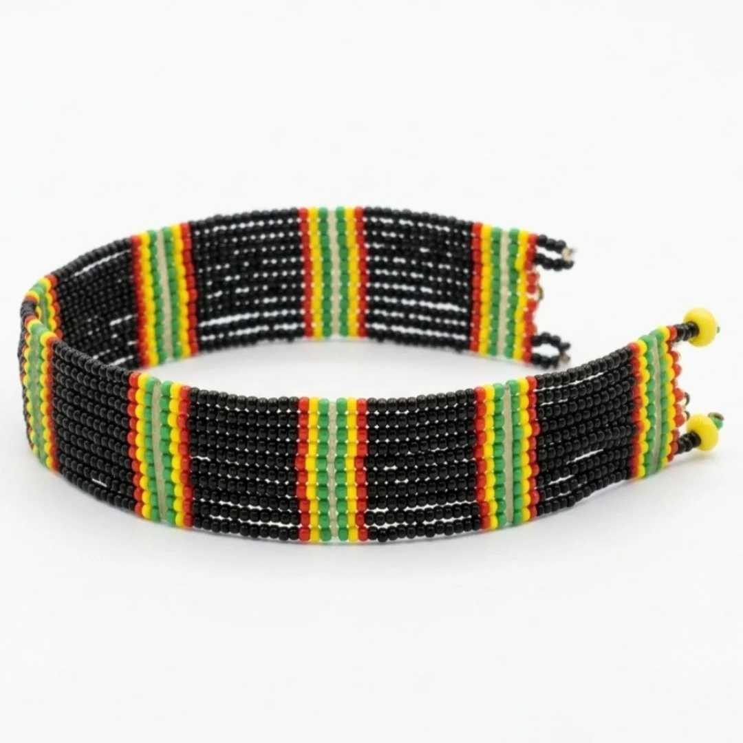 Colorful beaded necklace with black, yellow, red, and green beads on a white background.