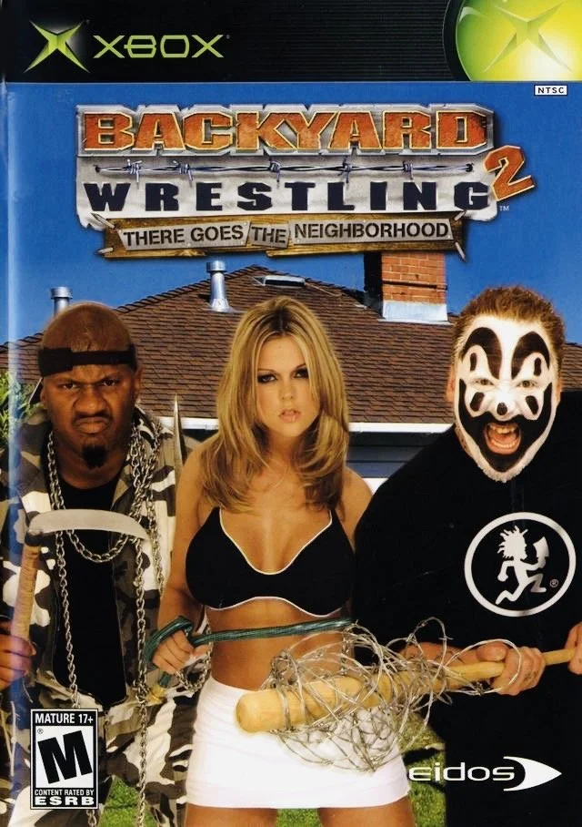 Video game cover for Xbox titled "Backyard Wrestling 2: There Goes the Neighborhood" featuring New Jack, ICP: Insane Clown Posse, and a woman in the center holding a baseball bat wrapped in barbed wire (background shows a house roof and a blue sky).