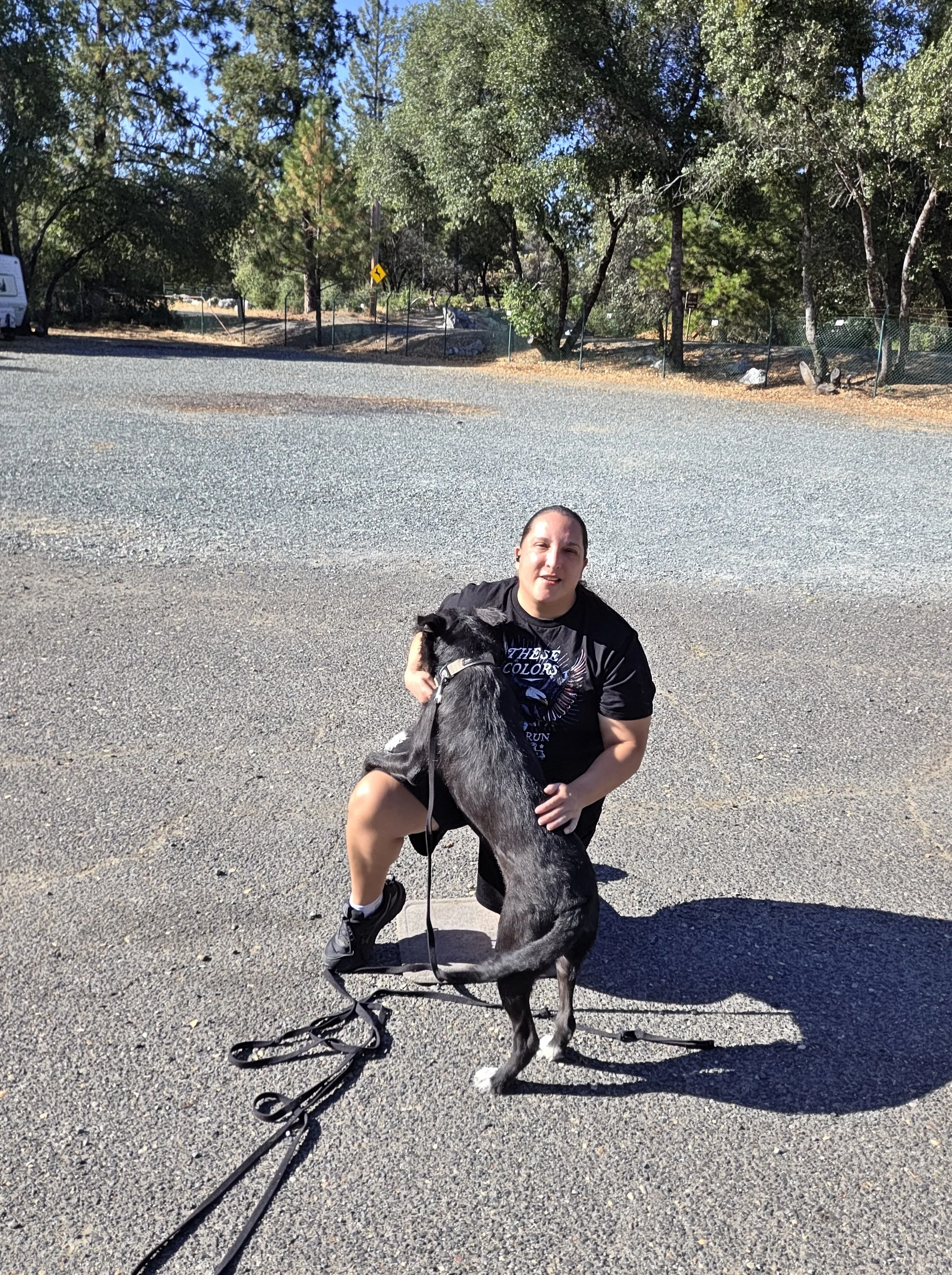 Desiree kneeling with her dog