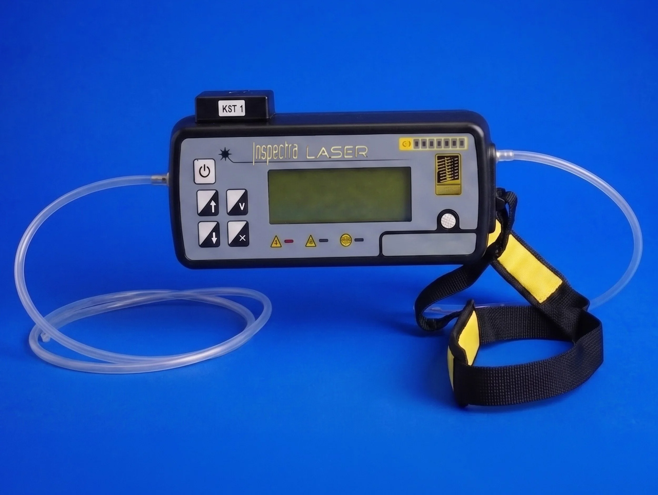 Medical device labeled 'Inspectra Laser' with a display screen, control buttons, connected tubing, and a strap with yellow and black colors, set against a blue background.