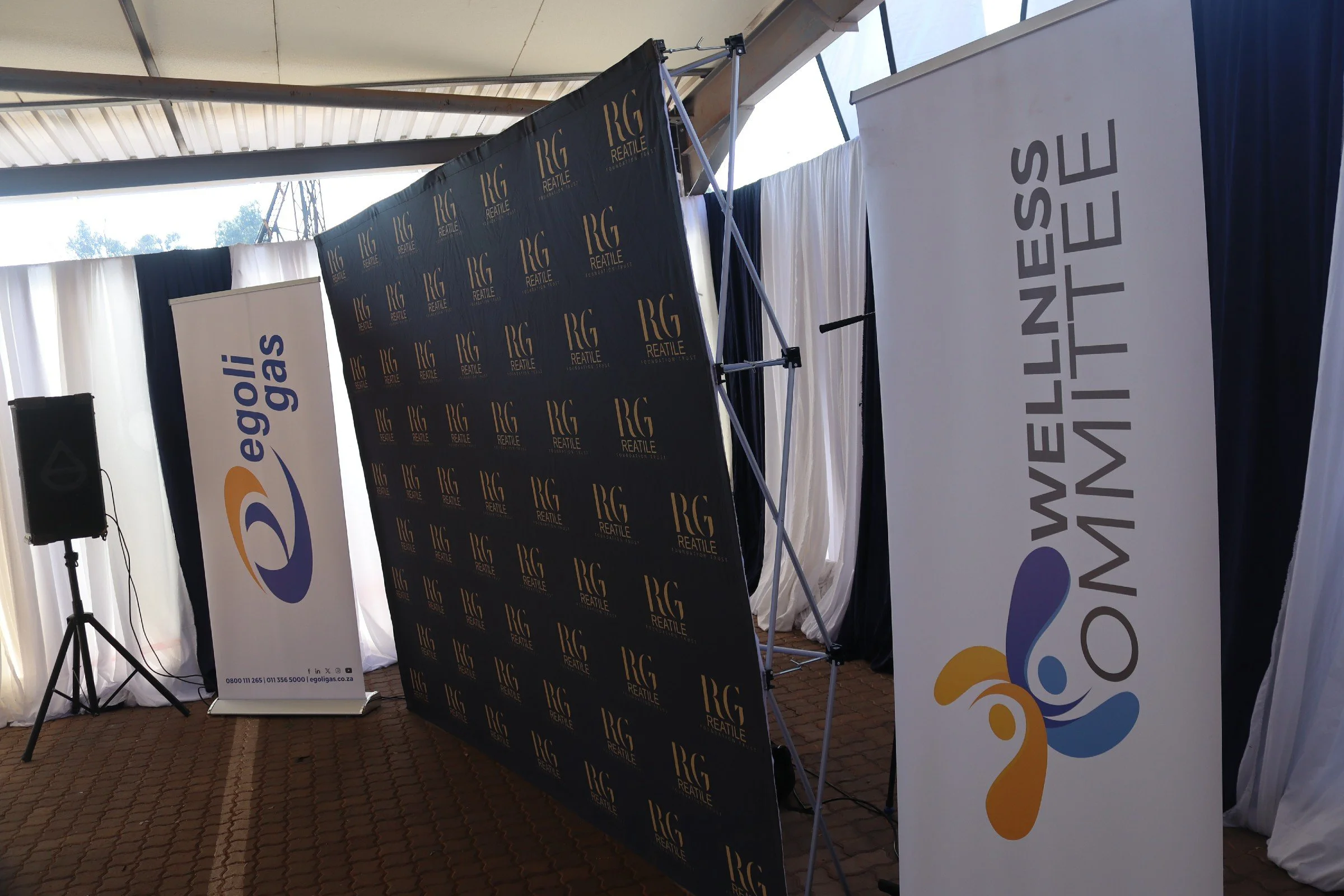 Event setup with banners and a speaker stand inside a tent, promoting Egoli Gas and Reatile Foundation.
