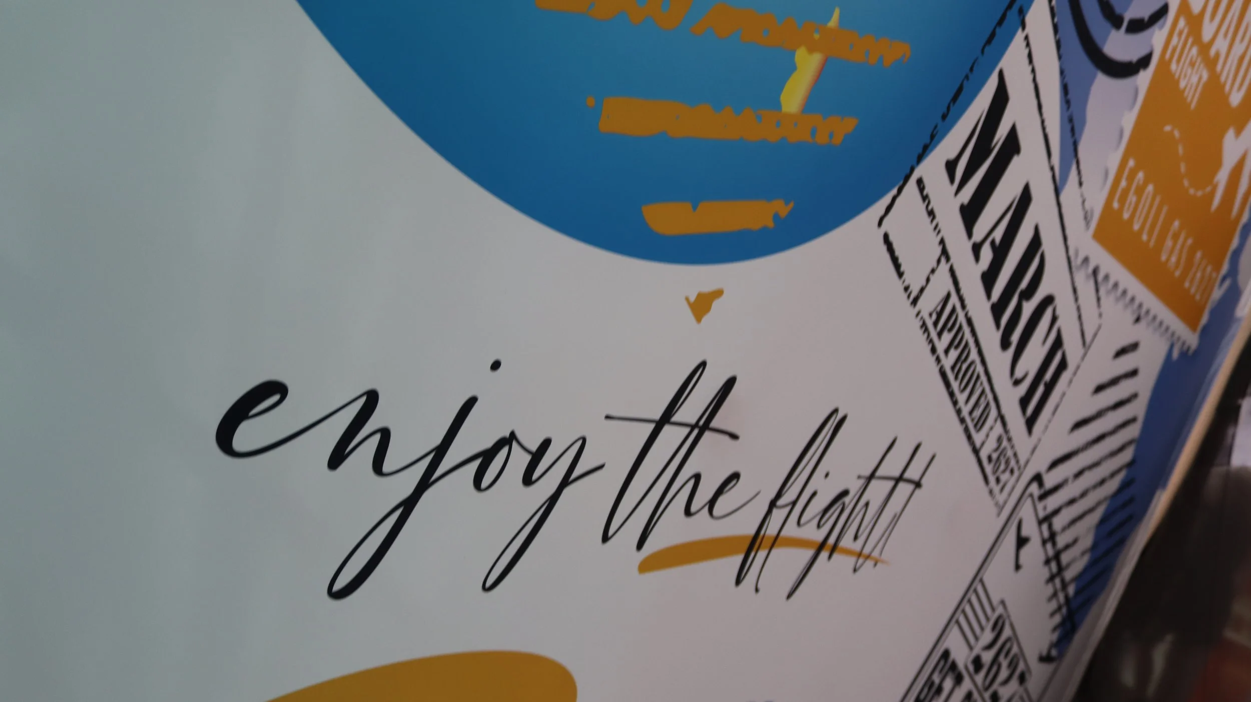 Close-up of a cereal box with the phrase "enjoy the light" written on it, and parts of text in yellow and black, including a barcode and other product details.