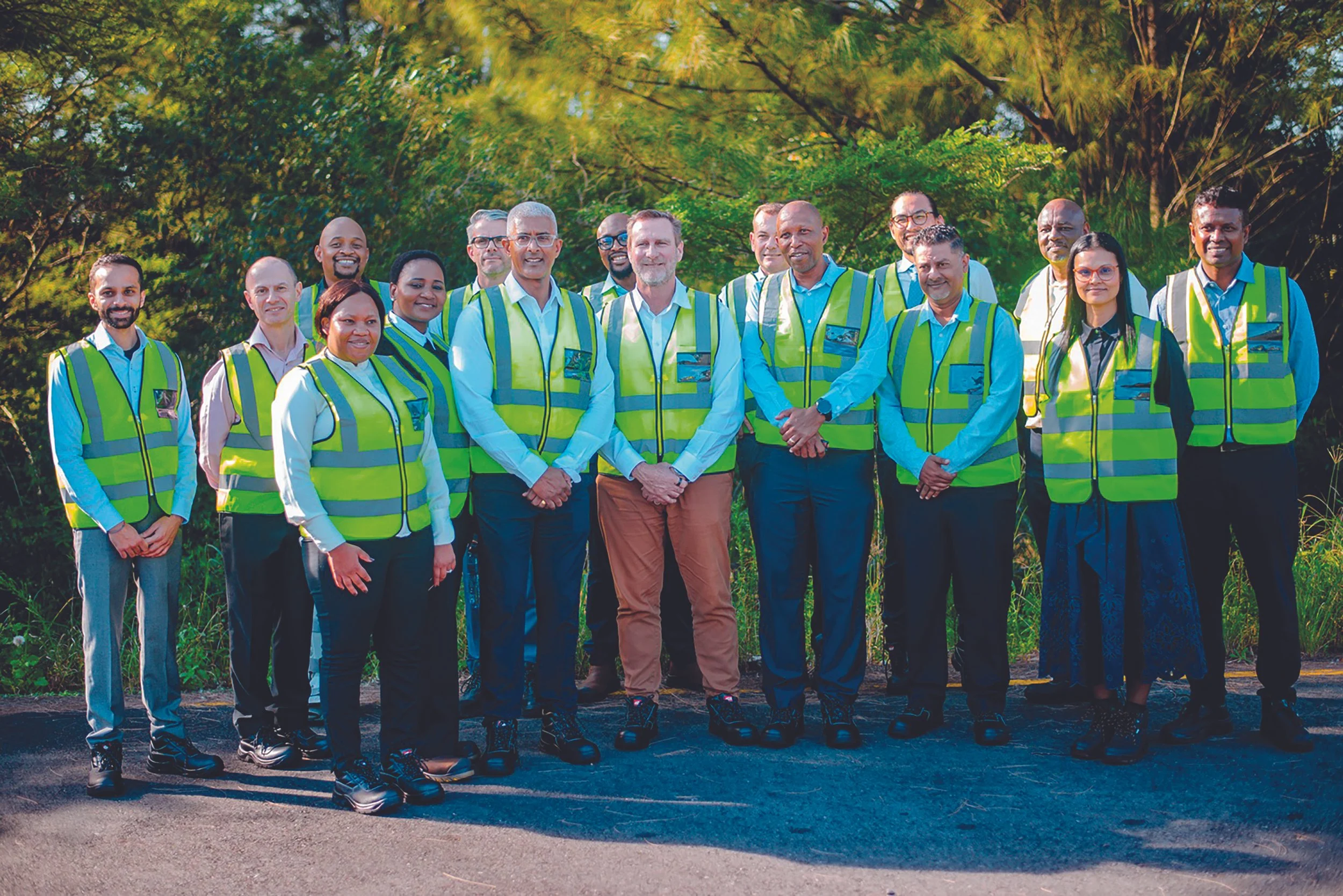 group of people in safety vests posing for a photo