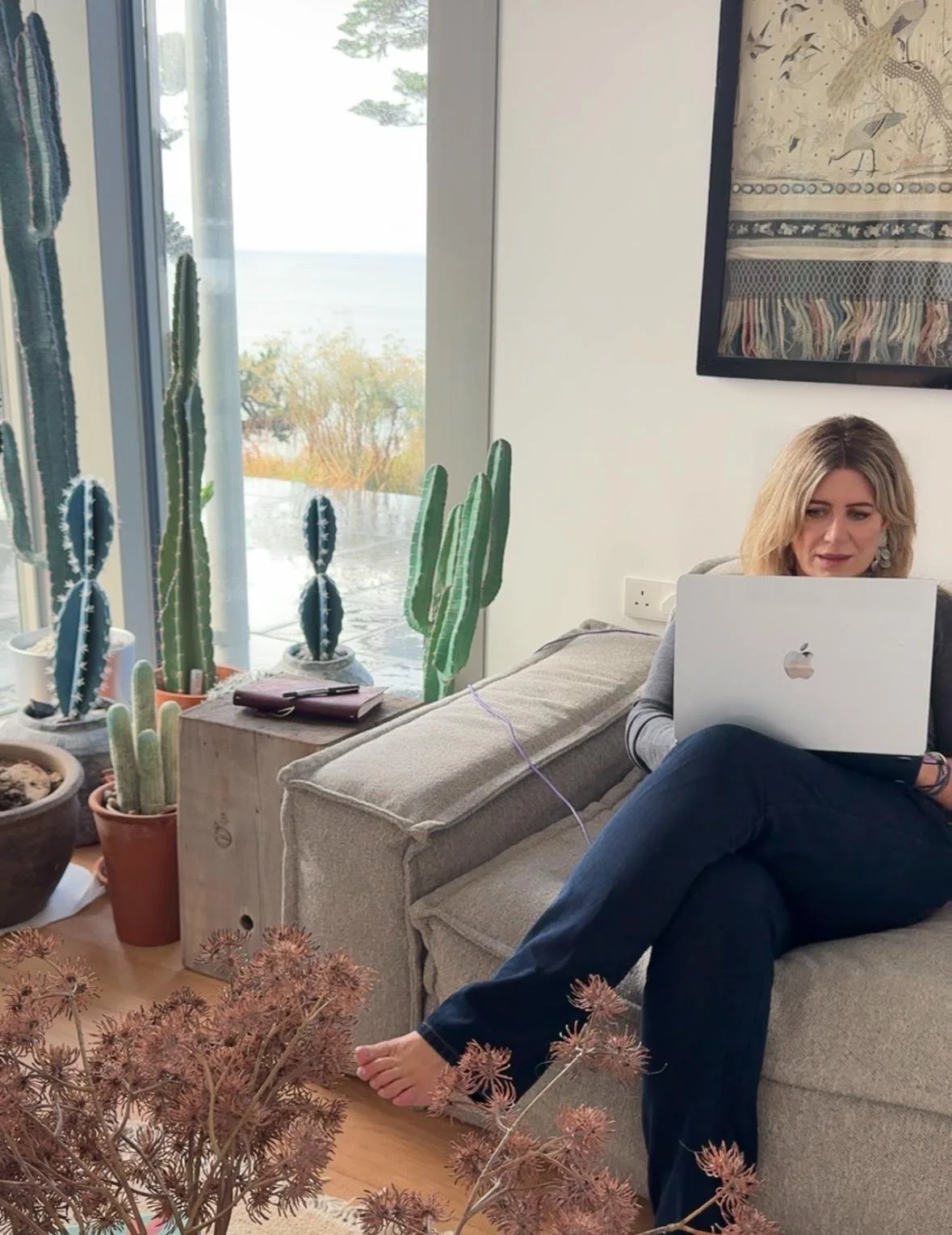 Jenny Ella writing on a laptop