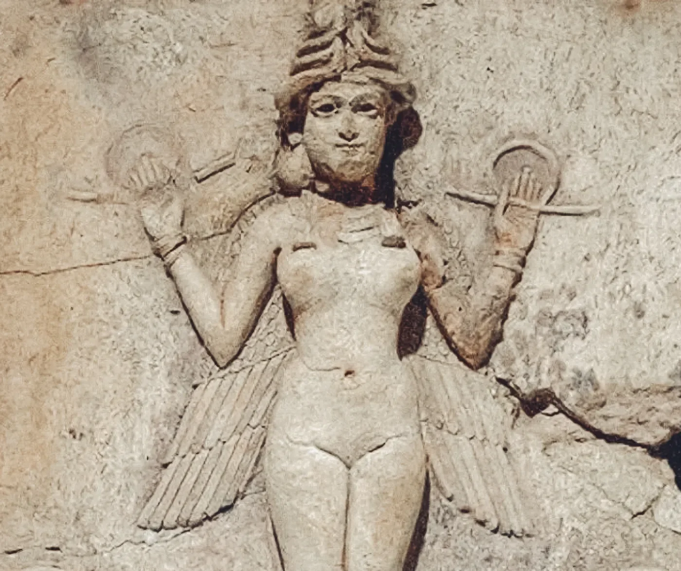 Sculptuur van een vrouwelijke godin met vleugels, kop met kroon en een staf in haar hand, uit de oude Mesopotamische kunst.