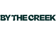 Logo met de tekst 'BY THE CREEK' in groene letters.