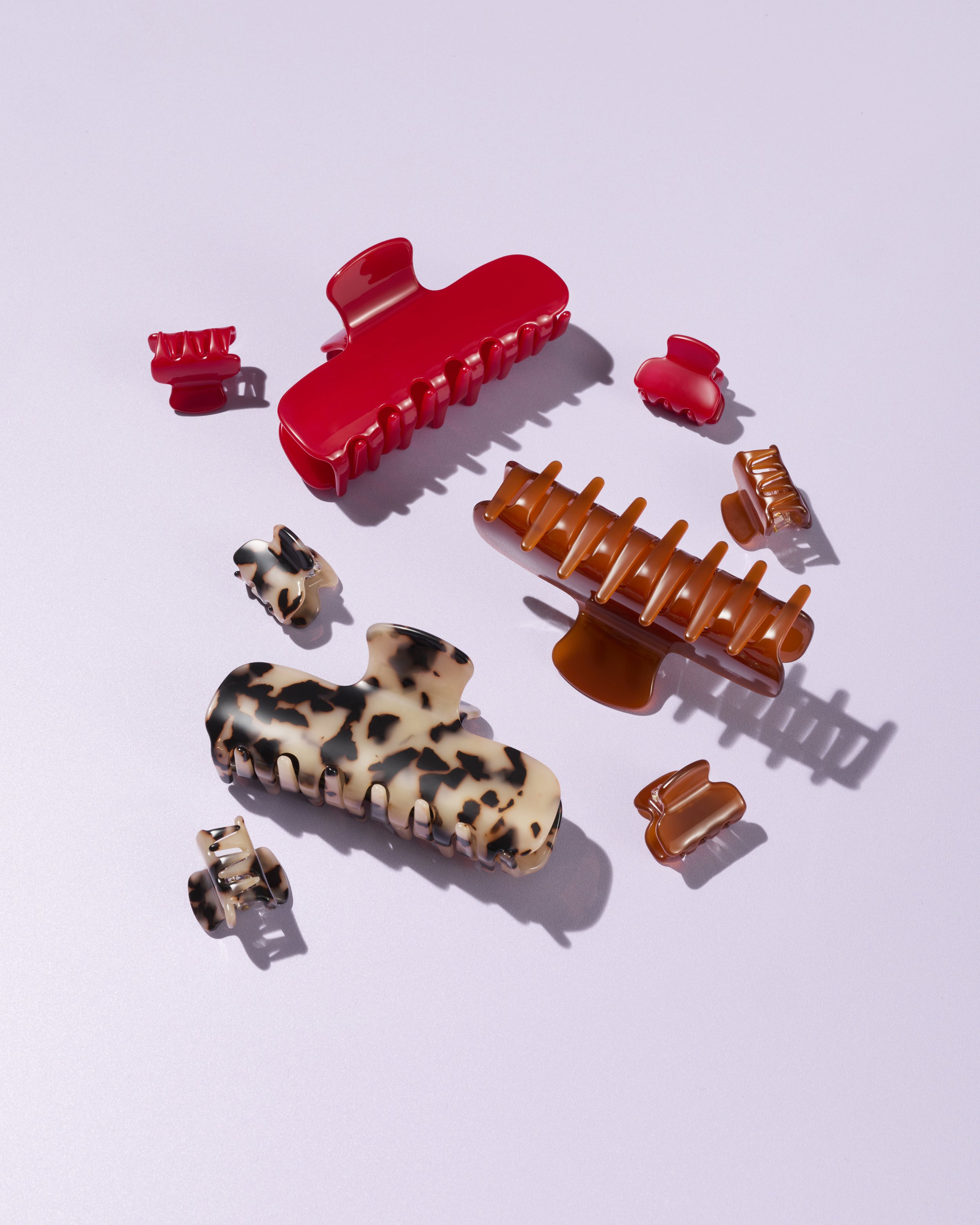 Hair Clips in red, brown and leopard print against a purple background