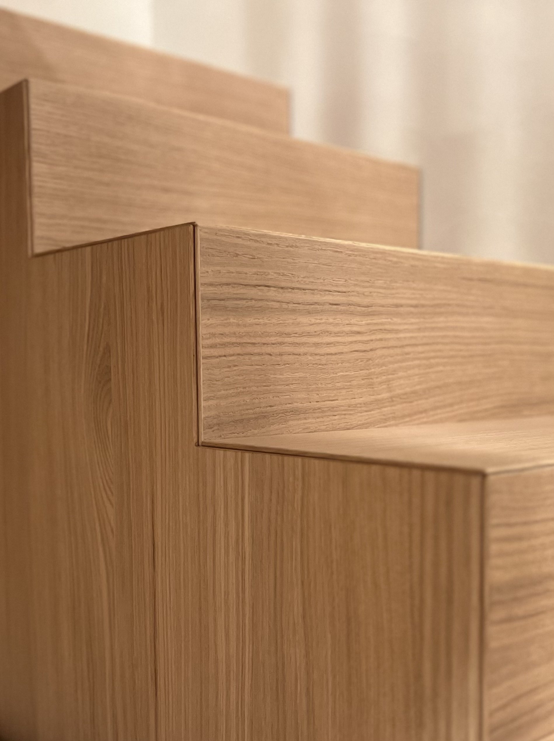 Close-up of interconnected wooden stairs with a modern minimalist design.