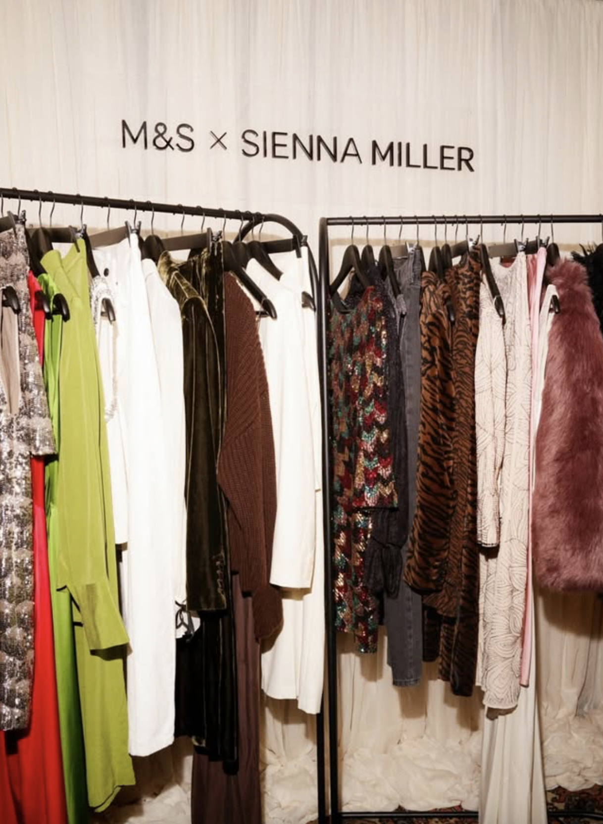 Clothing rack with dresses and garments at an Sienna Miller and Marks & Spencer collaboration display
