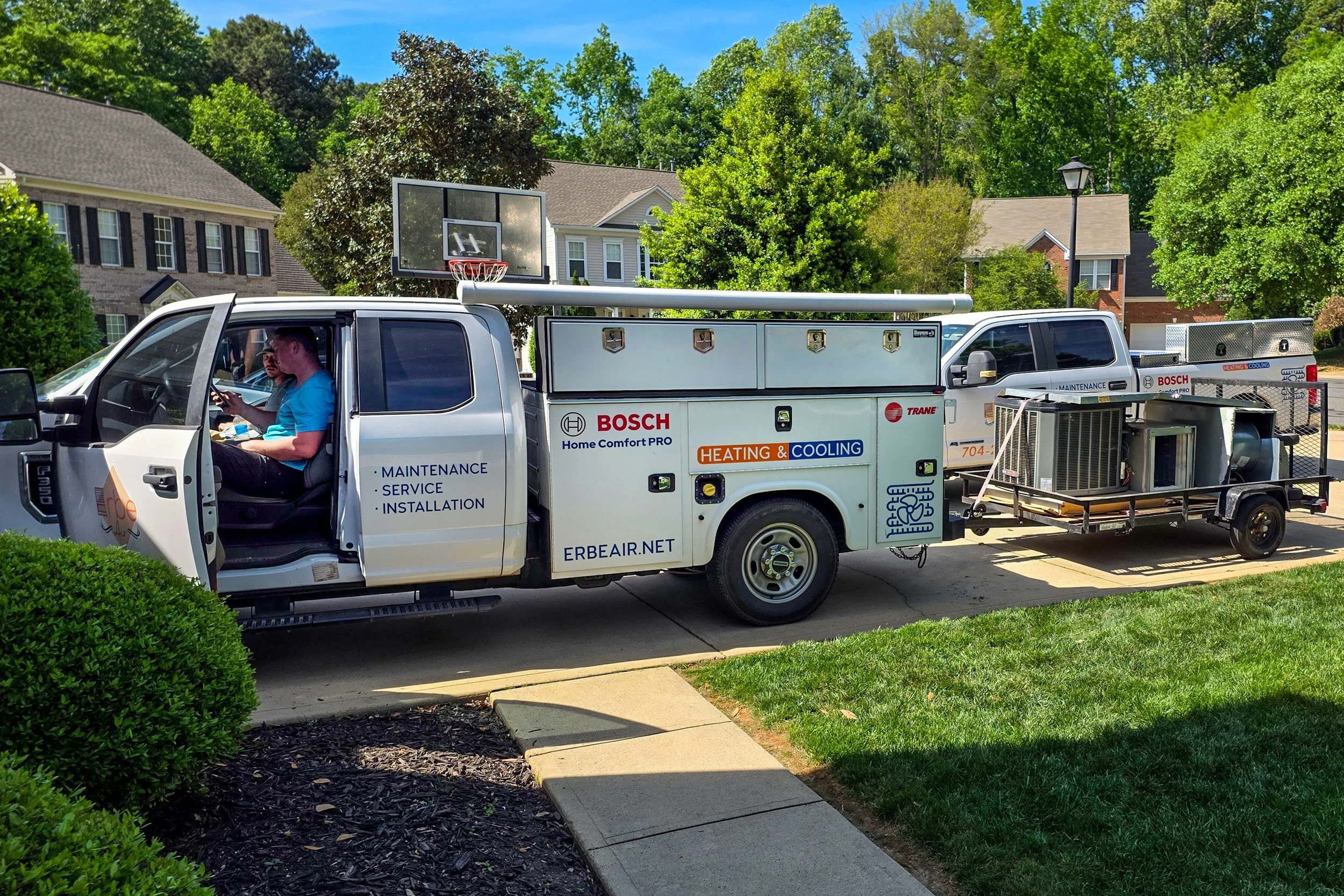 Photo of Erbe Air trucks after a successful installation of a new HVAC system in Charlotte NC.