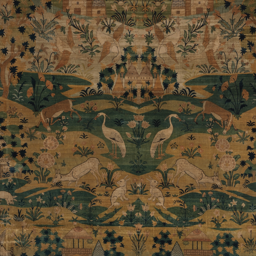 A detailed tapestry with animals such as cranes, deer, and rabbits, along with plants and flowers, in a traditional Asian artistic style.