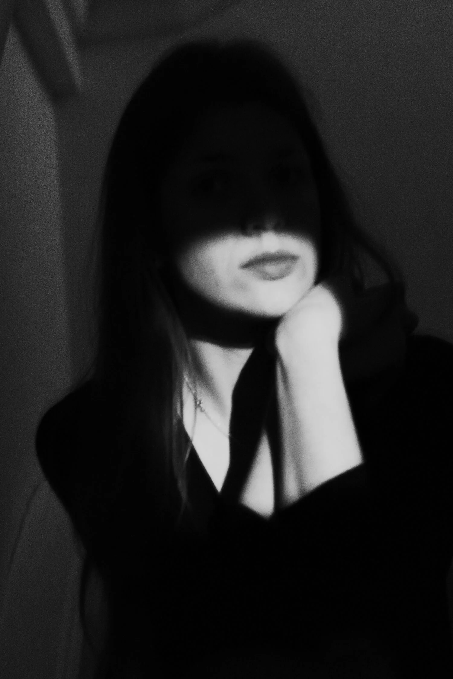 Detail of At Night by Ania Ready, a black-and-white portrait of a woman with dark hair covering her eyes.