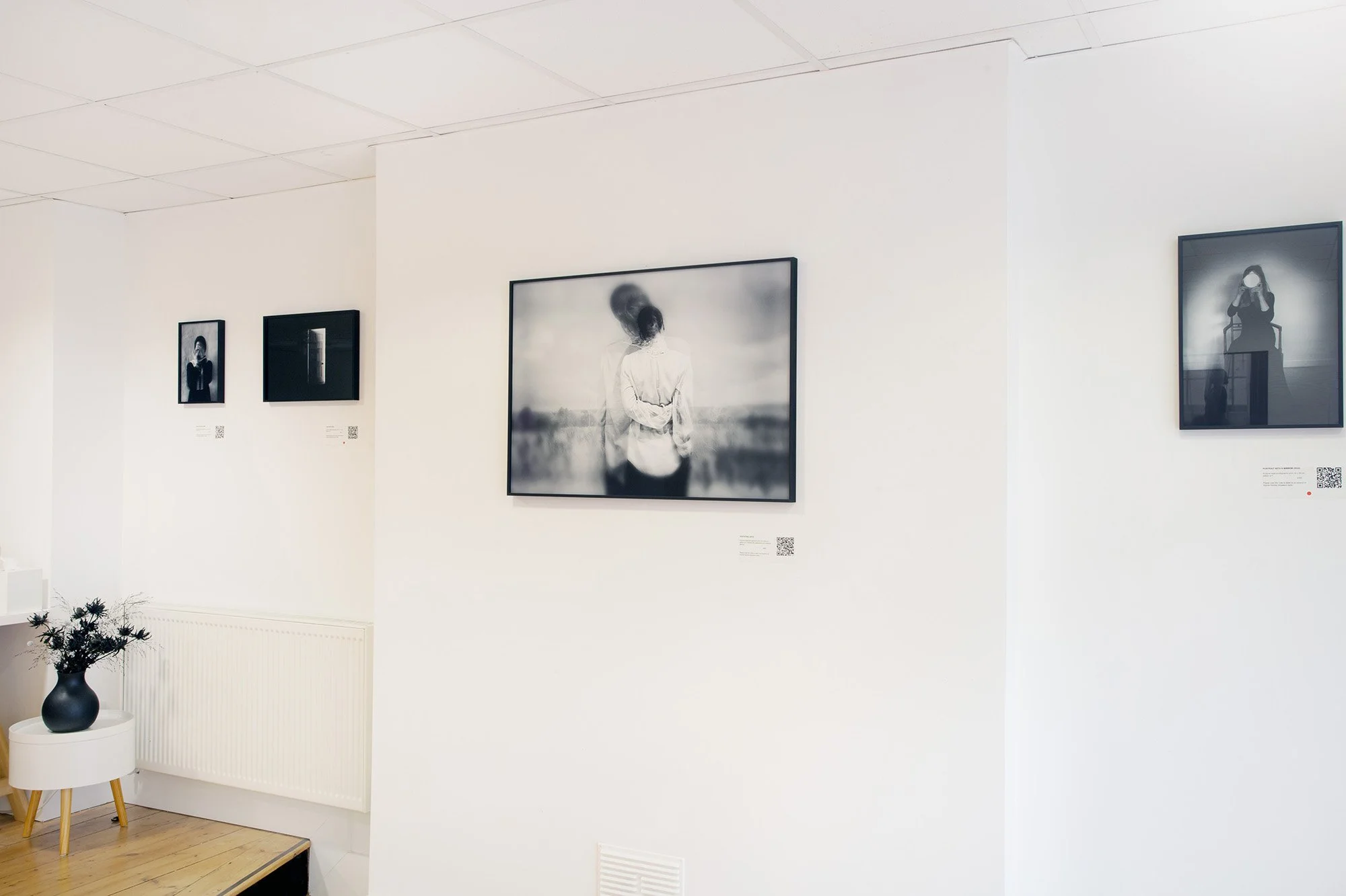 Installation view of I Also Fight Windmills, with framed black-and-white photographs displayed on white gallery walls.