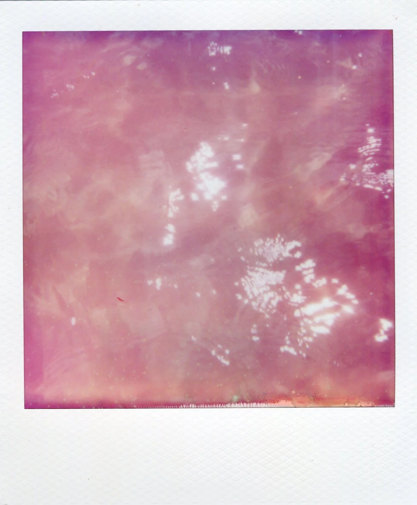 Detail of Water Mark (Baltic Sea) II, showing pale pink rippling seawater with bright reflected light.