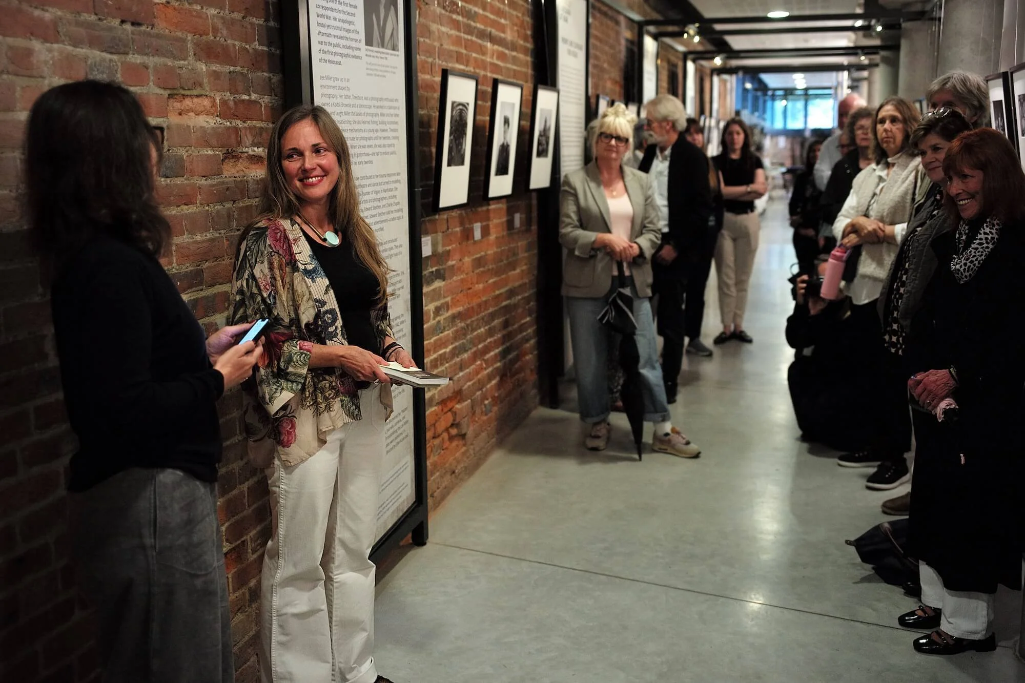 Ania Ready speaking to visitors during a tour of the Lee Miller exhibition.