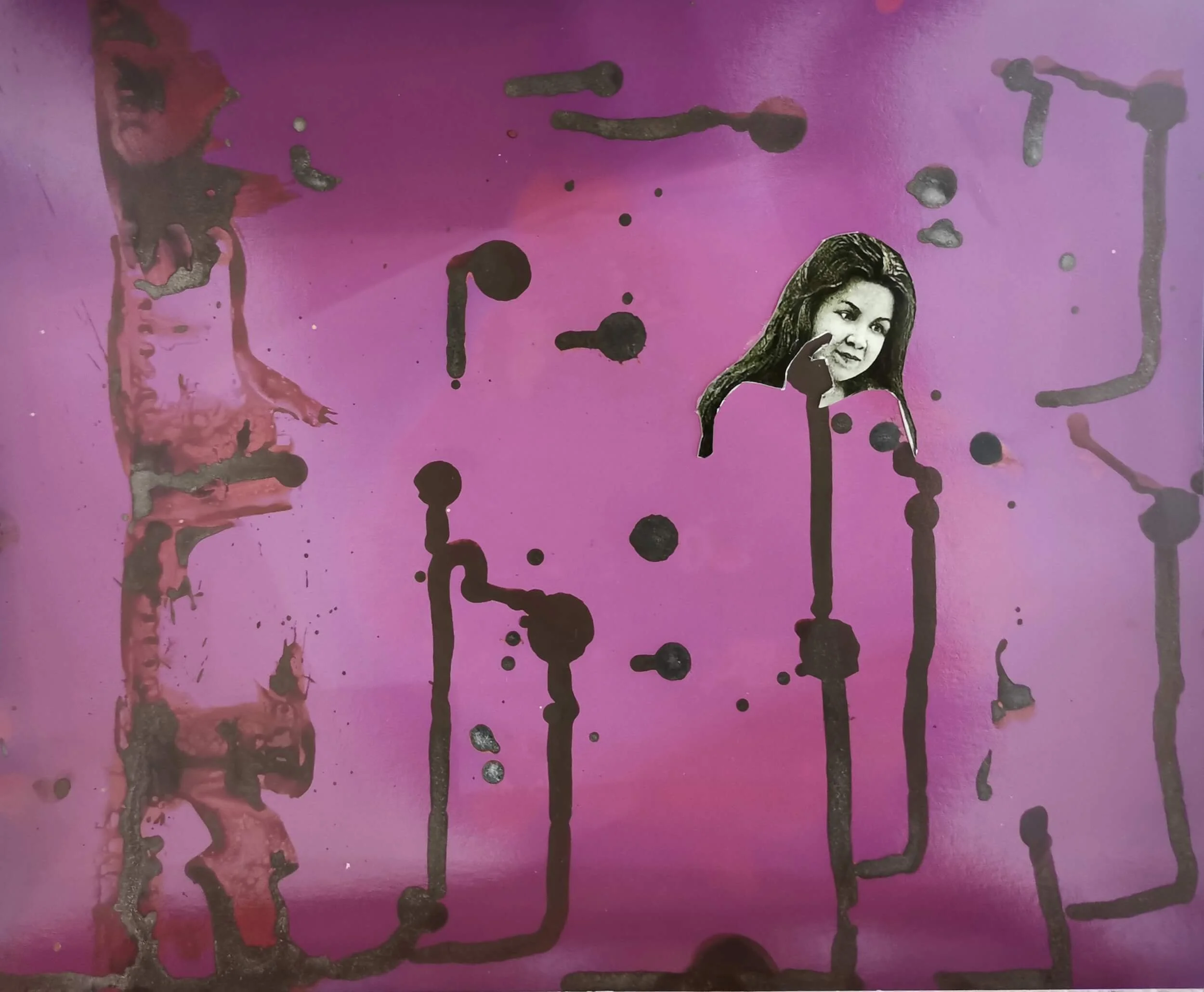 Hand-cut archival portrait of a woman suspended within a vivid pink chemigram with dark drips and marks.