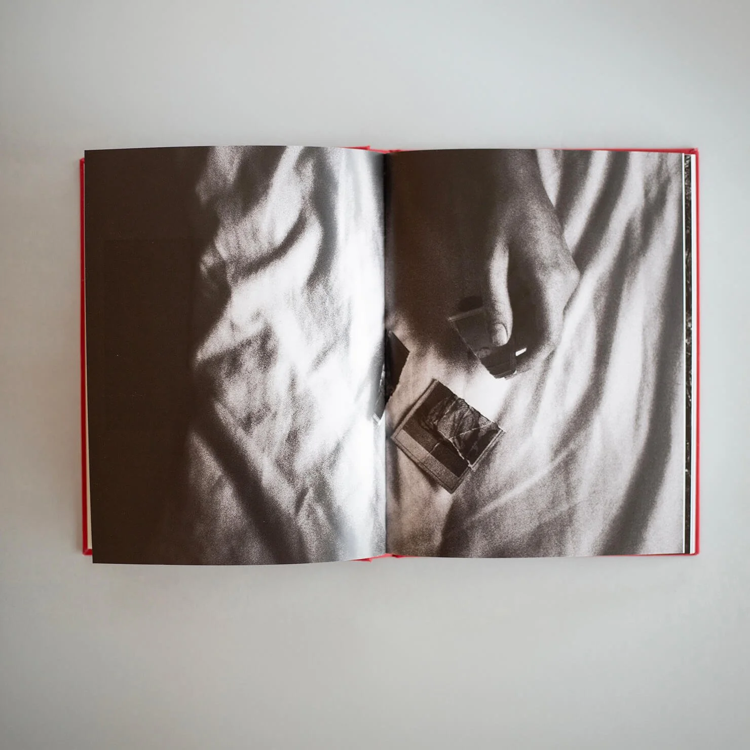 Open I Also Fight Windmills photobook showing a black-and-white photograph of a figure holding a small photograph.