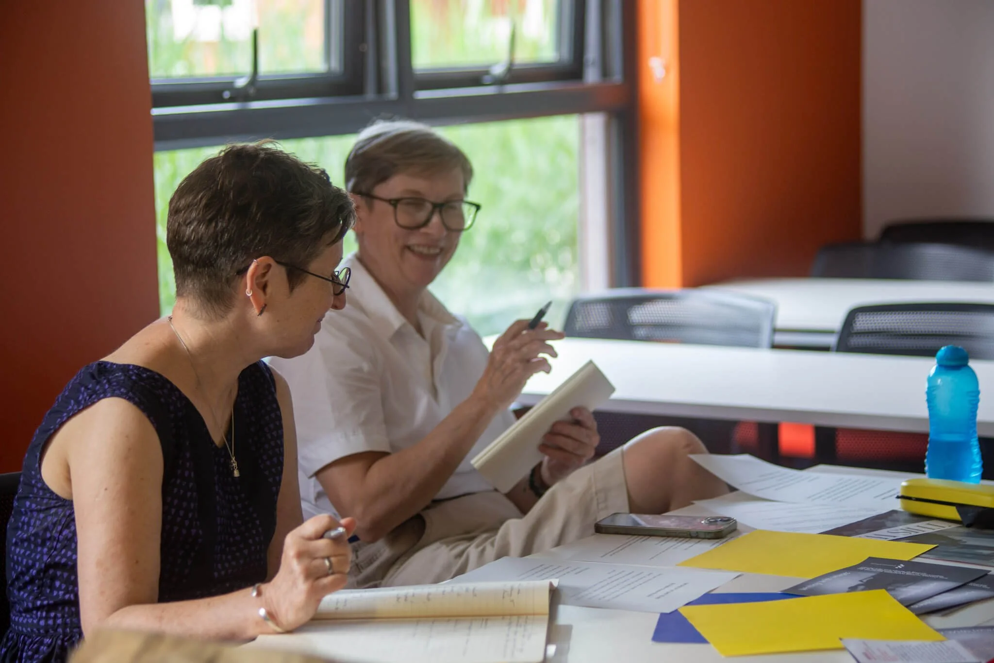 Participants writing and discussing their work during the Writing with Images workshop.