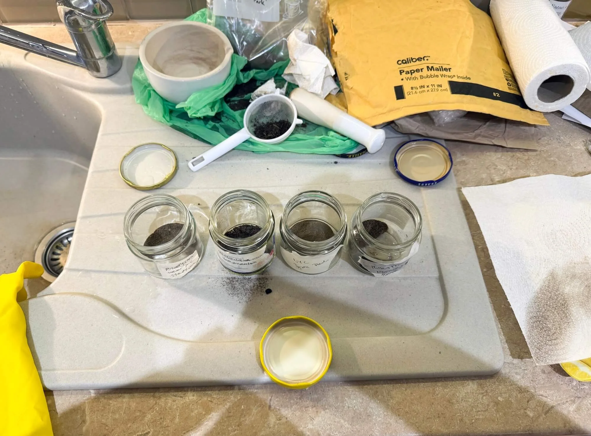 Jars containing soil samples and materials used to make soil chromatographs.