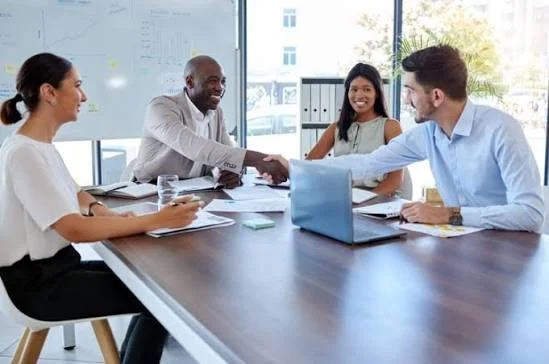 Joint venture attorney finalizing business partnership agreement with handshake