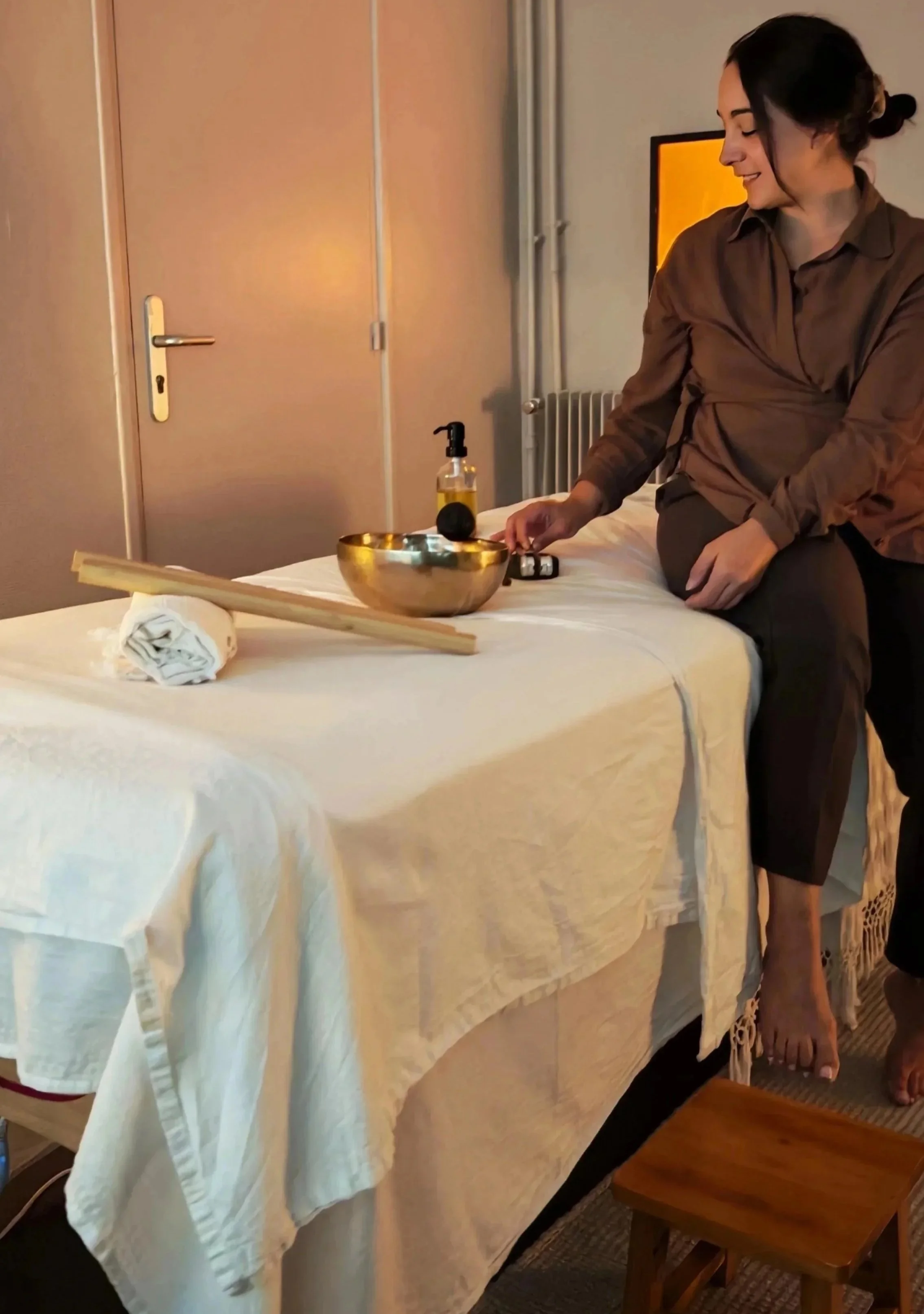Marie au sein de Sève féminine, sur sa table de soin accompagnée de son diapason, bol tibétain et son rebozo à Rouen