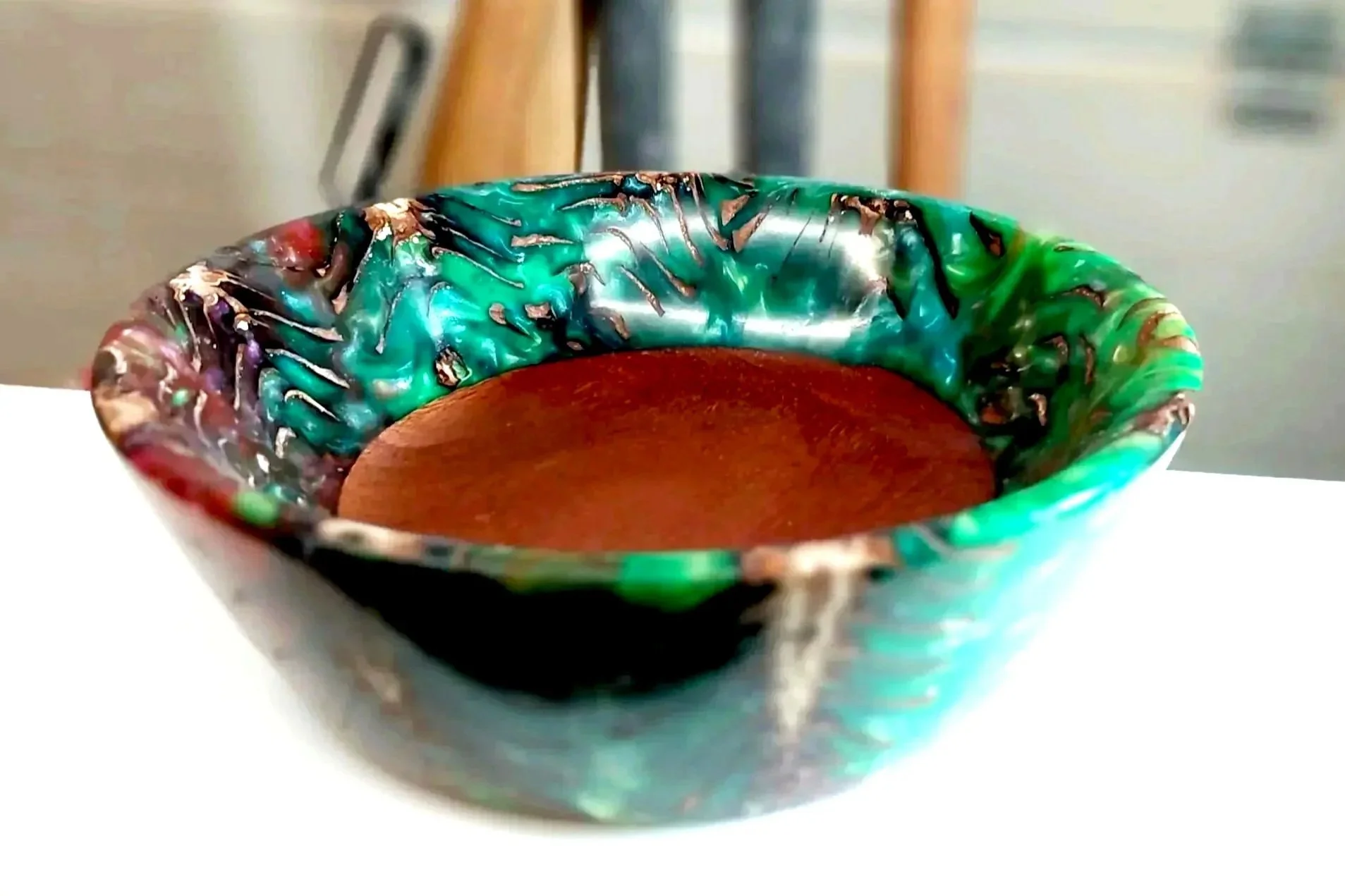 Colorful handcrafted wood and resin art bowl by Art by Herb, featuring swirling green and red tones.