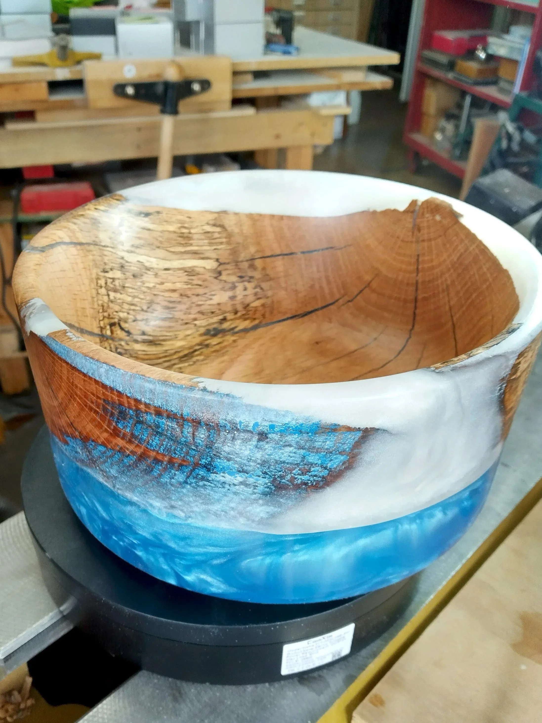 Handcrafted wood bowl by Art by Herb, shown on a lathe during the turning process.