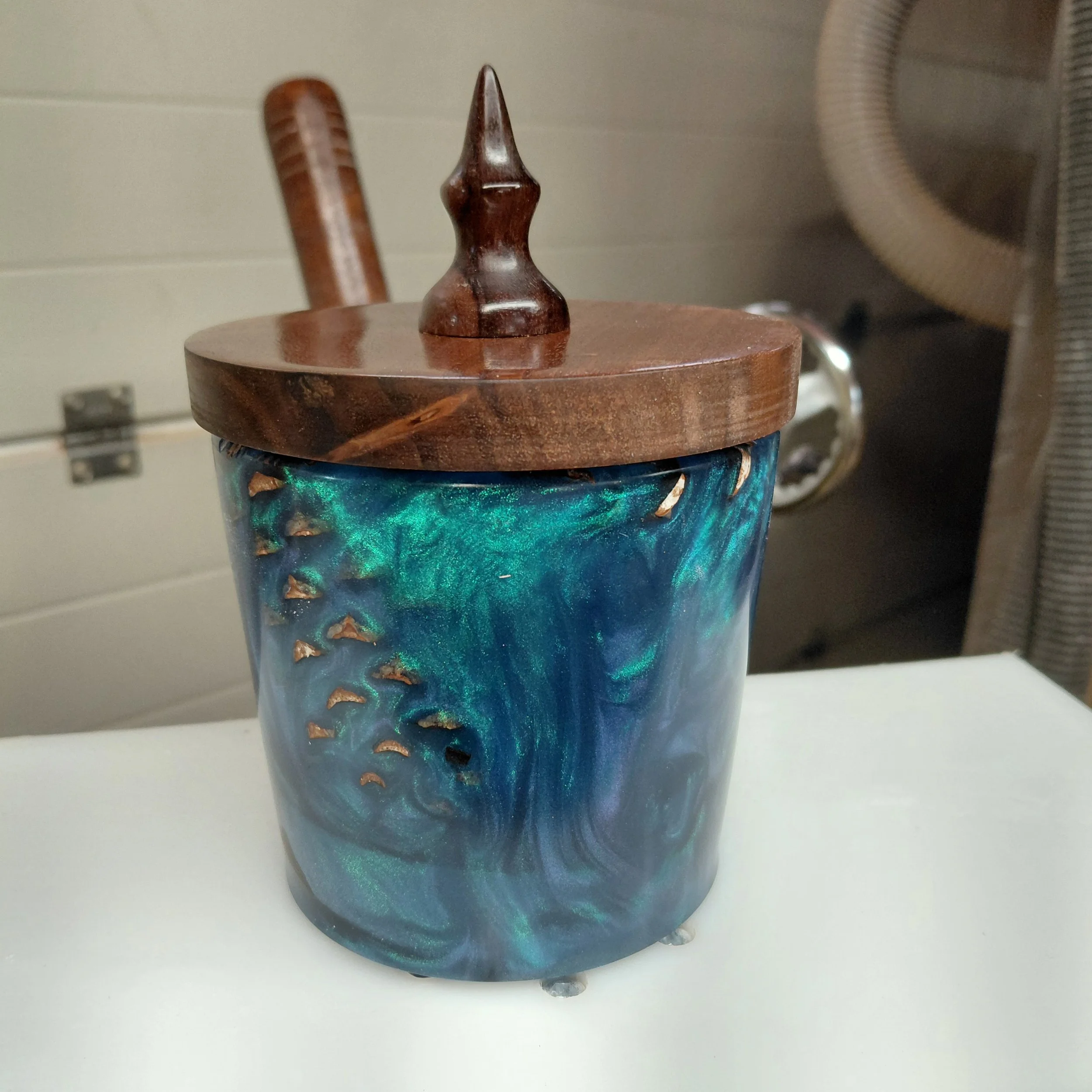 Blue-green glazed vessel with a handcrafted wooden lid and decorative finial by Art by Herb.