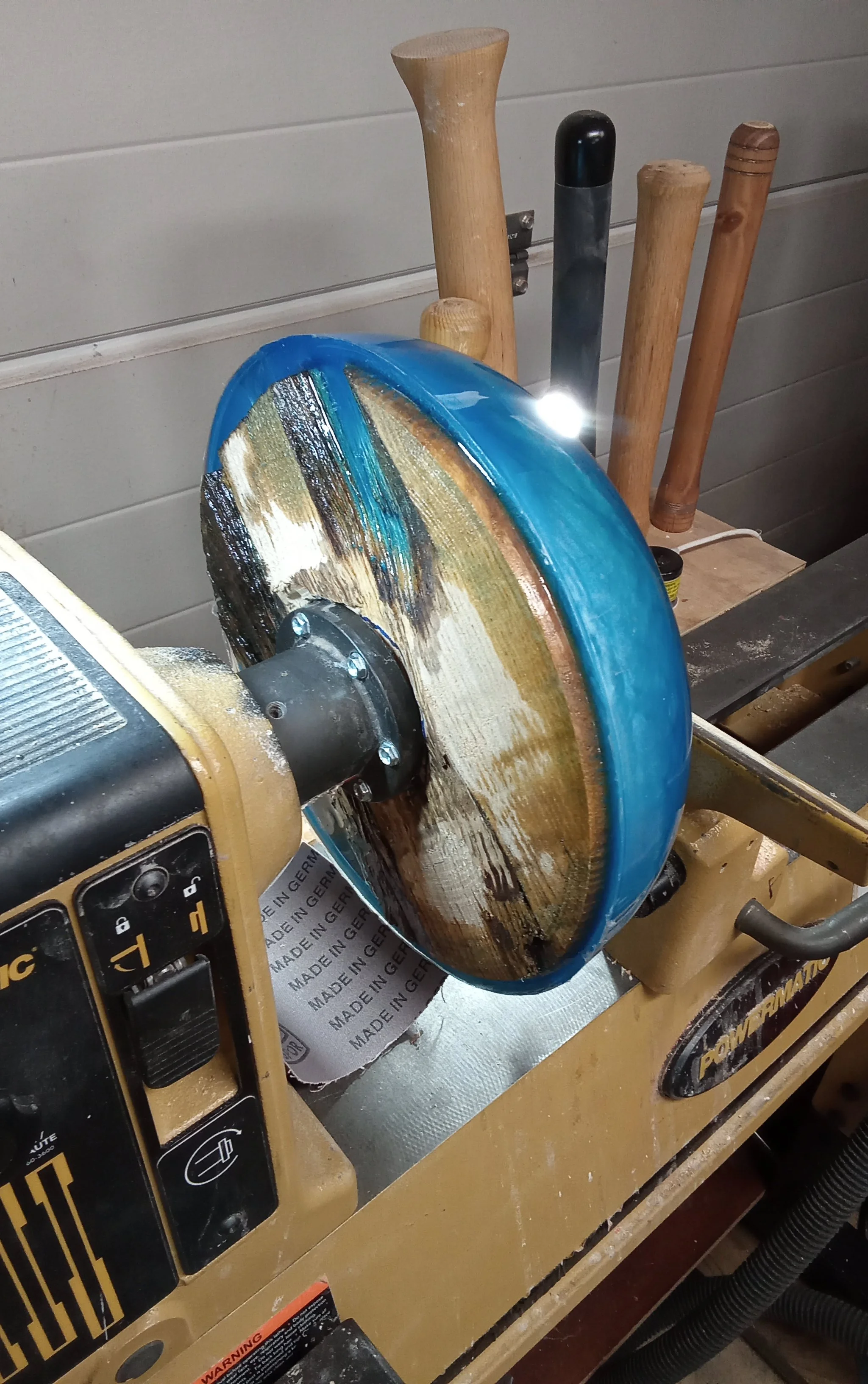 Handcrafted wood bowl being shaped on a lathe in the Art by Herb workshop.