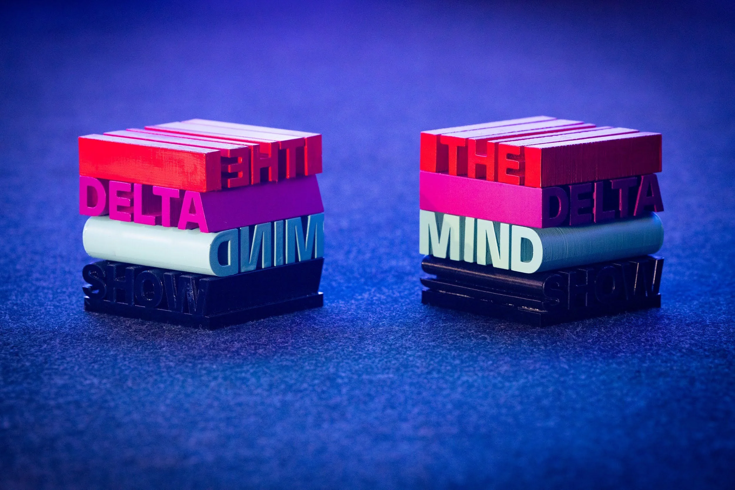 Two sets of small colorful blocks with raised letters spelling out "THE,
