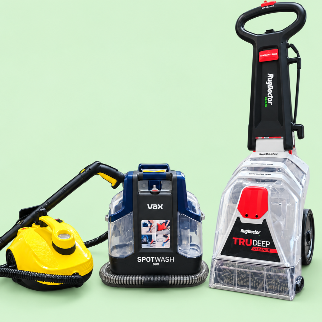 Carpet cleaning equipment includes a yellow handheld steam cleaner, a blue portable spot wash with a hose, and a large upright deep cleaner with a black handle and a transparent water tank.