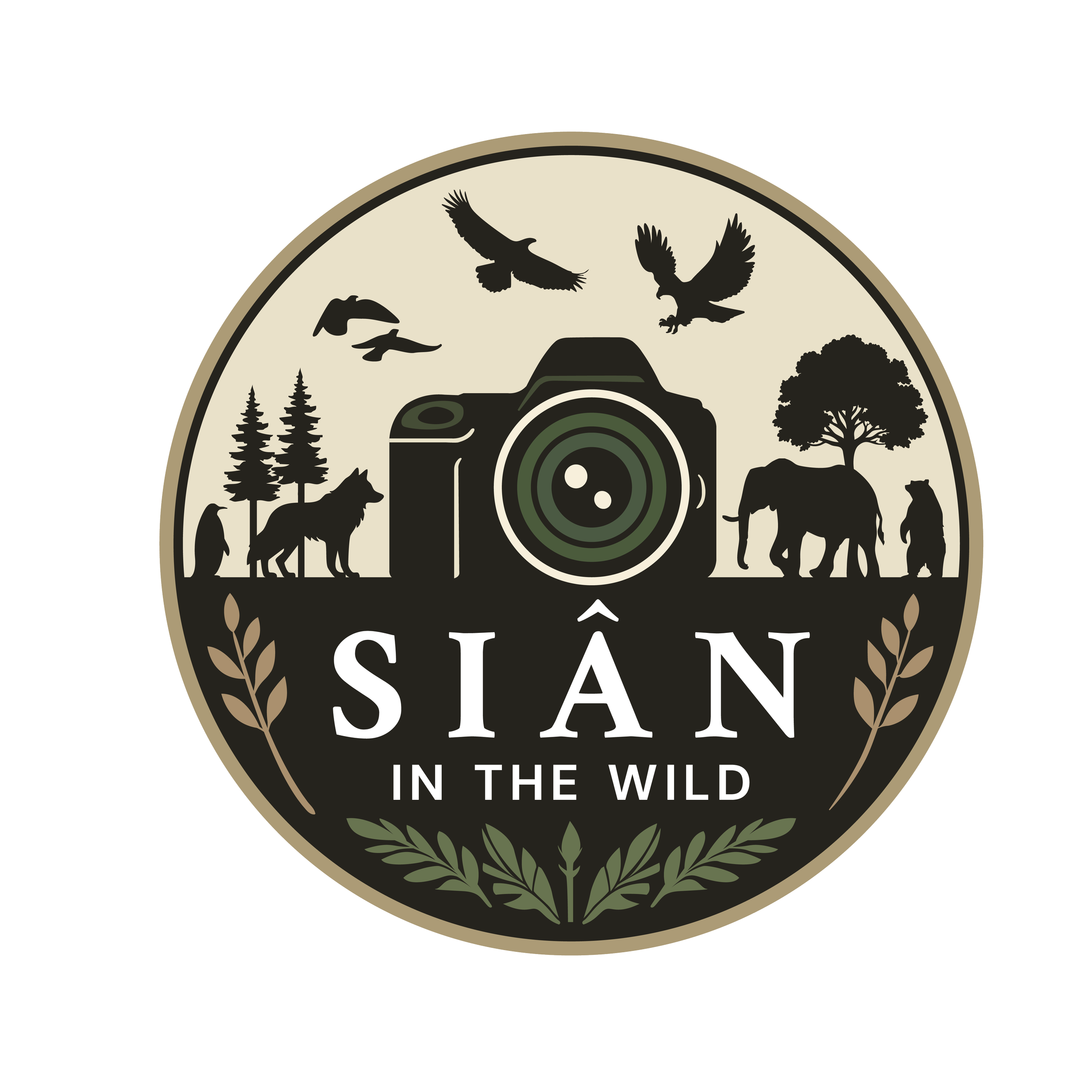 A wildlife-themed logo featuring a camera in the center, surrounded by silhouettes of birds, trees, and animals, with the words "In the Wild" at the bottom.
