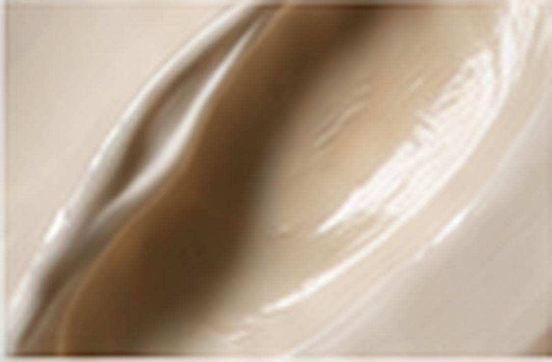 Close-up of a beige-colored object with smooth, curved lines and a glossy surface.