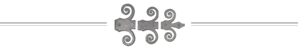 Close-up of a metal decorative piece with swirling designs and a central arrow element, against a black background.