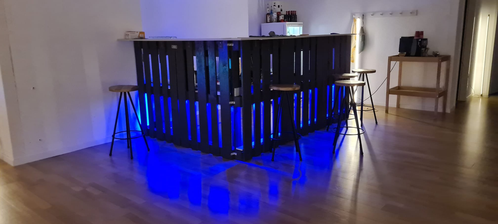 Industrial bar corner with fridge and coffee machine in a Zurich rental studio