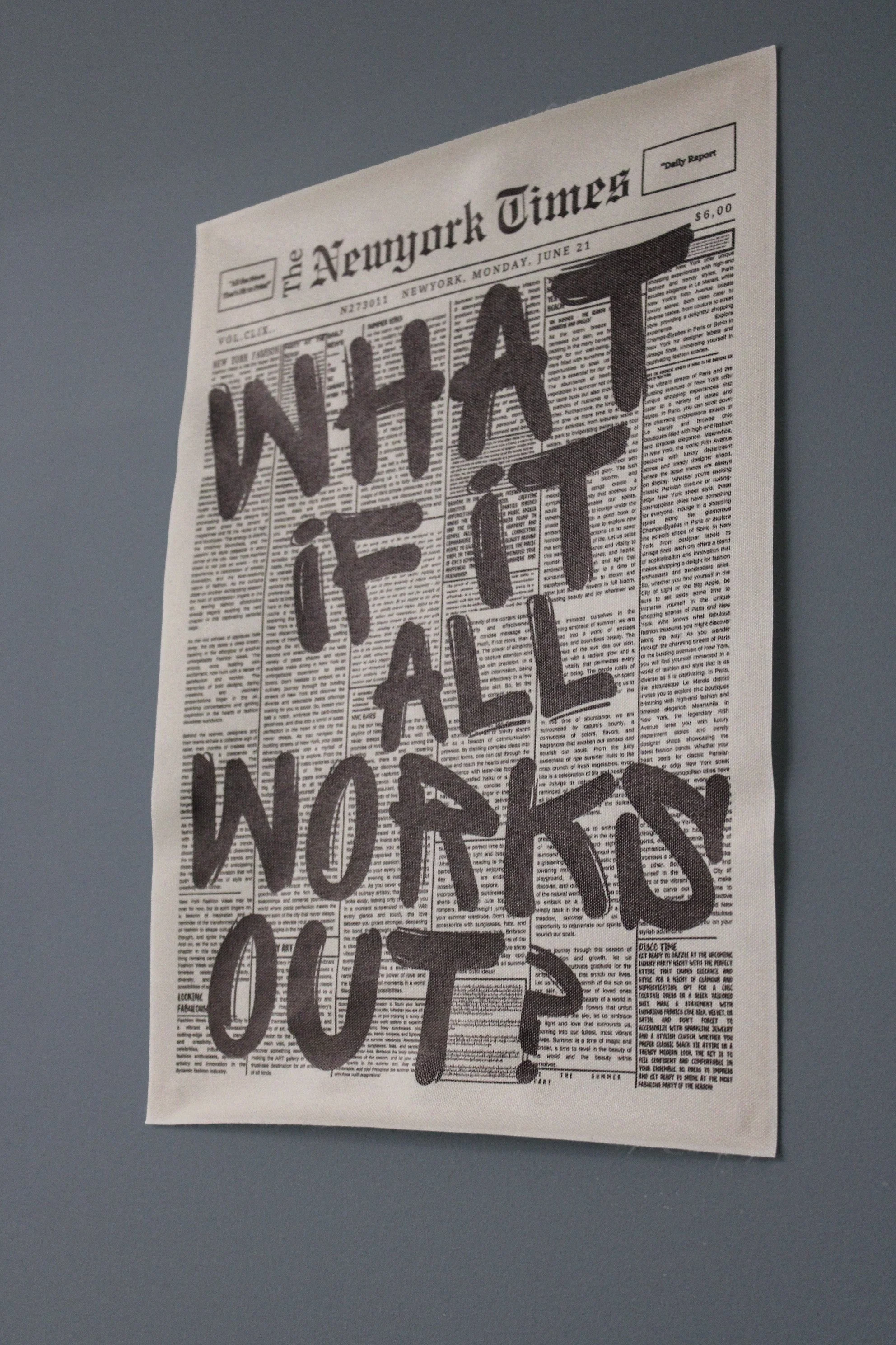 A newspaper with bold handwritten-style text that says "WHAT I GIVE A SHIT ABOUT" overlaid on top of it.