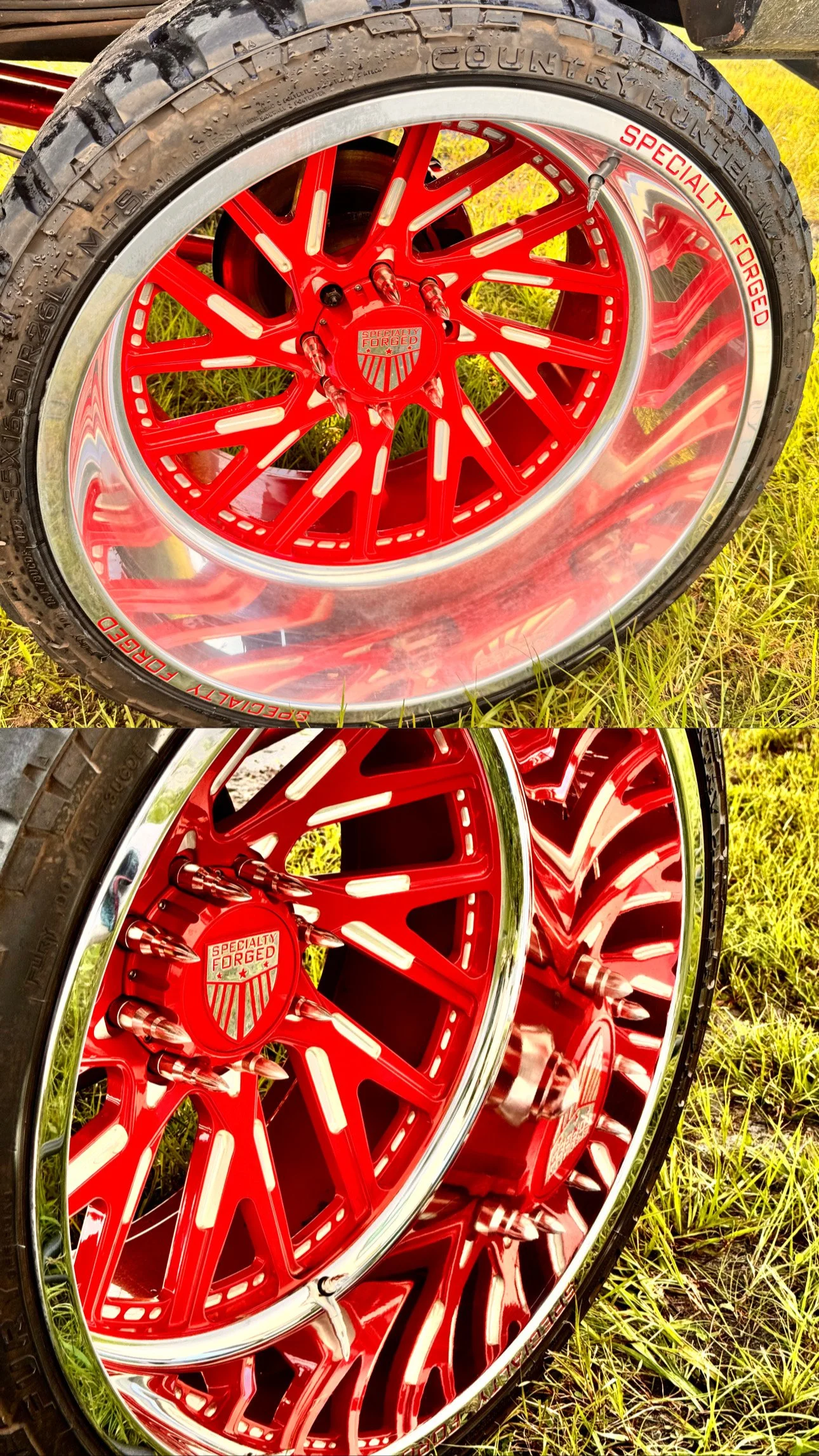 Close-up of red custom car wheels with chrome trim, mounted on tires, on grass ground.