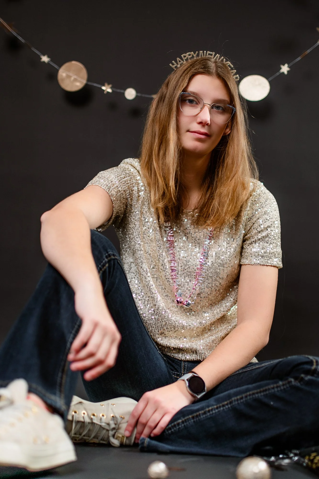 Editorial style senior portrait featuring a high school senior in a metallic top and headband against a moody studio backdrop in North Central Indiana.