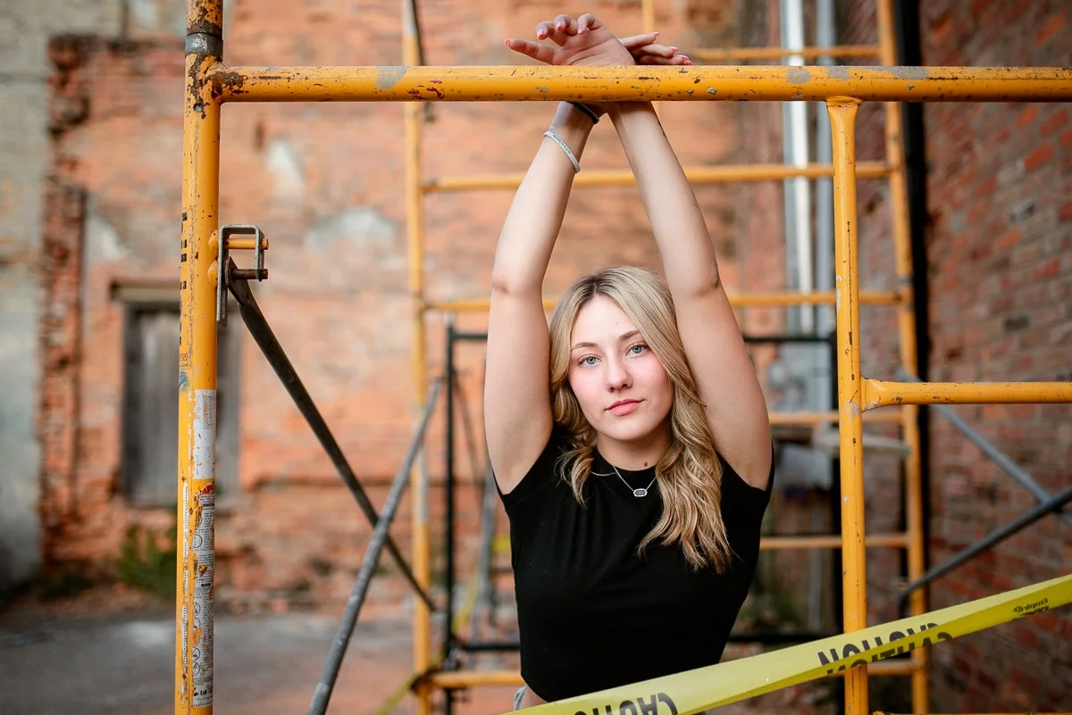 Urban style senior portrait session featuring a high school senior against industrial scaffolding in North Central Indiana