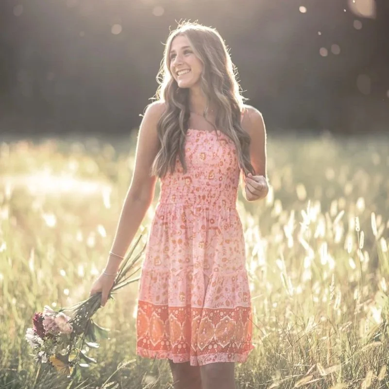 Sun-soaked golden hour senior portrait session in a natural wildflower field by North Central Indiana photographer Rebecca Danielle.