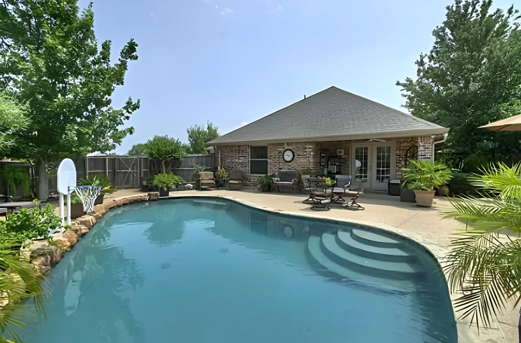 Backyard pool and patio at Selah Ridge assisted living home in Denton, TX