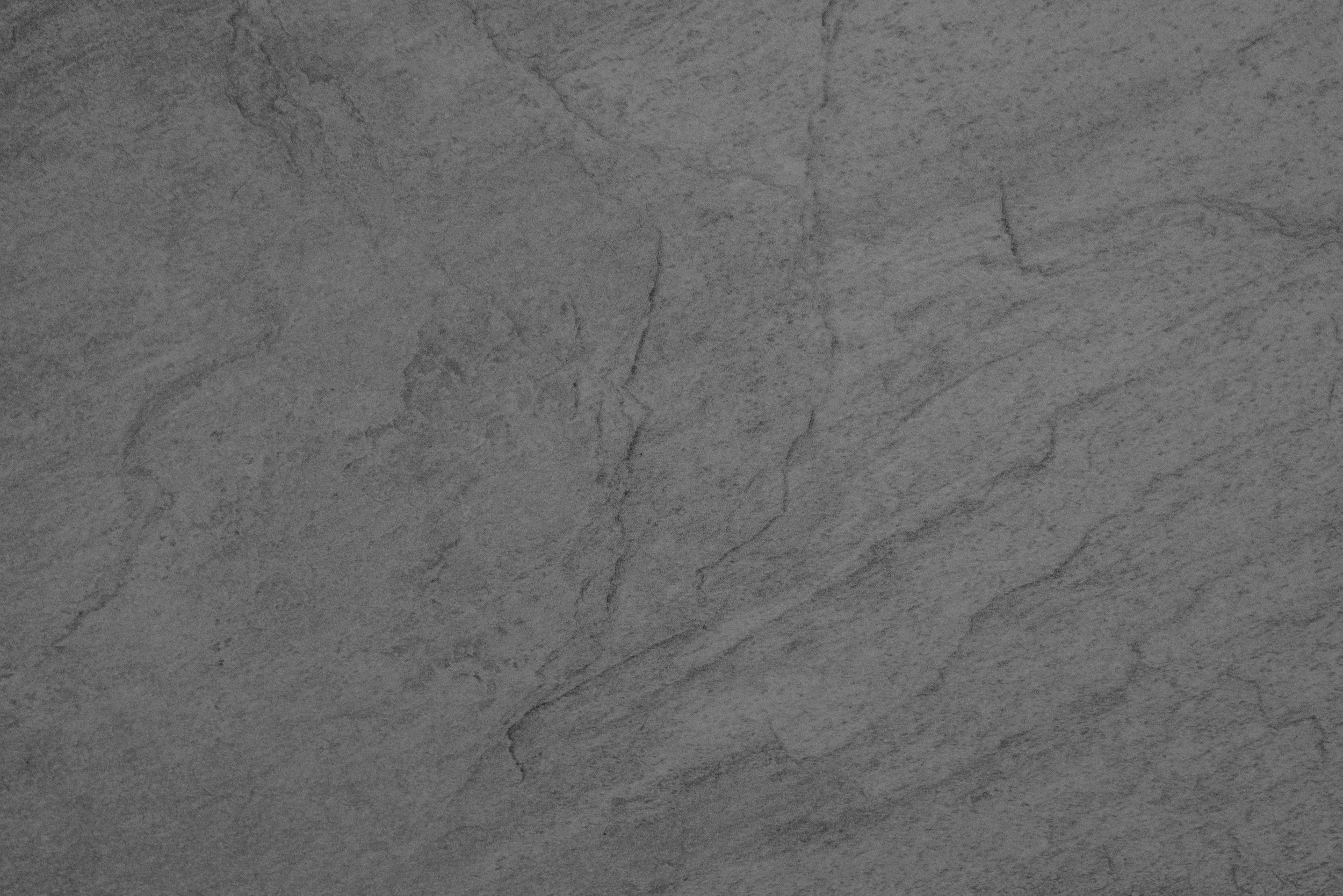 Gray stone surface with subtle cracks and natural textures.