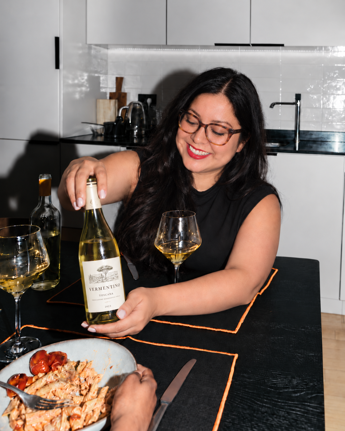 woman holding white wine bottle