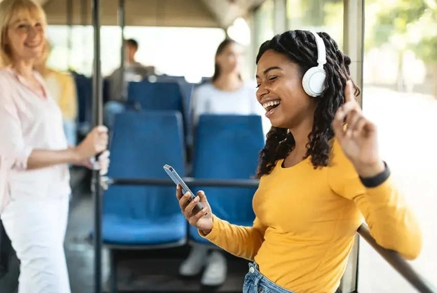 A picture of a woman dancing in the bus
